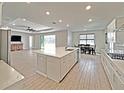 Modern kitchen featuring a large center island with sink, stainless steel appliances, and an adjacent dining area at 6488 Sw 78Th Ct, Ocala, FL 34474