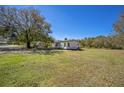 A charming single-story home set on a large grassy lot with mature trees, offering a serene and spacious setting at 1140 Saddlewood Blvd, Lakeland, FL 33809