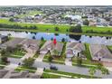 Aerial view of the home with a spacious backyard overlooking a tranquil pond in a Gathering-friendly neighborhood at 2163 Plantation Oak Dr, Orlando, FL 32824