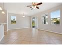 Bright living room featuring neutral tile floors, recessed lighting, and sliding glass doors to the outside at 9147 Shepton St, Orlando, FL 32825