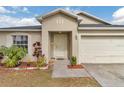 Inviting front entryway with decorative landscaping and a well-maintained exterior at 114 Briarcliff Dr, Kissimmee, FL 34758