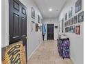 Hallway with tiled floors, decorated walls, and recessed lighting leading to other rooms at 114 Briarcliff Dr, Kissimmee, FL 34758