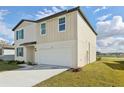 A modern two-story home displaying a spacious two-car garage and a neatly kept lawn at 2122 Rosewood Dr, Bartow, FL 33830