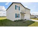 Two story home with a lush green lawn featuring an attached garage and well-maintained landscaping at 2122 Rosewood Dr, Bartow, FL 33830