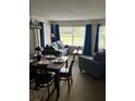 Comfortable and quaint living room with plush seating and natural light from multiple windows at 6337 Parc Corniche Dr # 2101, Orlando, FL 32821