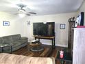 Spacious living room featuring wood floors, a ceiling fan, and neutral wall paint at 663 Hager St, Deltona, FL 32725