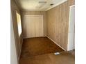A bedroom with wood-paneled walls, a closet, and hardwood floors at 102 Center Sw St, Winter Haven, FL 33880