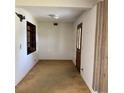 The entry room features a front door, carpeted floors, and a window at 102 Center Sw St, Winter Haven, FL 33880