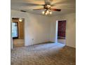 Spacious living room featuring a ceiling fan and doorways leading to other rooms at 102 Center Sw St, Winter Haven, FL 33880