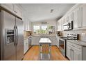 Bright kitchen with stainless appliances, granite countertops, and sunlit bay window at 3017 Wekiva Rd, Tavares, FL 32778