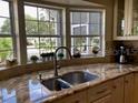 Charming kitchen area with bright sink and granite countertop at 3017 Wekiva Rd, Tavares, FL 32778