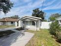 Charming single-story home featuring a covered front porch, a spacious driveway, and fenced yard at 301 Bassedena N Cir, Lakeland, FL 33805