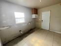 Kitchen area with a window, awaiting modern updates and featuring tile flooring at 301 Bassedena N Cir, Lakeland, FL 33805