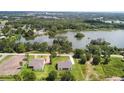 Aerial view of homes, including a lake view, in a serene community at 2569 Rogers Rd, Lakeland, FL 33812