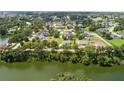 Scenic aerial view of a lakeside community surrounded by lush trees at 2569 Rogers Rd, Lakeland, FL 33812