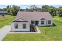 Well-manicured lawn and landscaping highlight this beautiful single Gathering home with gray trim at 2569 Rogers Rd, Lakeland, FL 33812