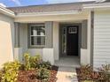 Close-up of the home's entrance, showcasing the stylish front door and elegant trim at 2569 Rogers Rd, Lakeland, FL 33812