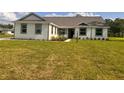 Attractive single-story home featuring a manicured lawn and stylish exterior at 2569 Rogers Rd, Lakeland, FL 33812
