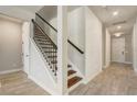 View of a staircase with dark wood and a white wall, located near the entrance of the home at 5618 Winterbrook Way, Winter Park, FL 32792