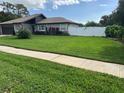 Well-manicured front lawn with lush green grass that enhances the curb appeal of this lovely home at 223 W Panama Rd, Winter Springs, FL 32708