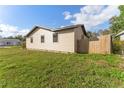 View of the side of home featuring a grassy yard with privacy fence at 2730 Woodland Hills Ave, Lakeland, FL 33803