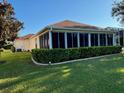 Enjoy the beauty of this home's serene view with large screened-in patio perfect for relaxing at 348 Ellenton Run, The Villages, FL 32162