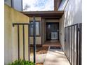 View of the house entrance and gated courtyard with black metal fence and tile flooring at 3808 Ne 17Th St # 3808, Ocala, FL 34470