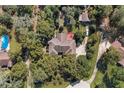 Aerial view of home featuring a spacious yard, pool, and mature trees at 5670 Sw 34Th St, Ocala, FL 34474