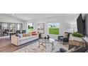 Open living room with comfortable seating, large windows, and stylish decor at 263 Puma Loop, Groveland, FL 34736