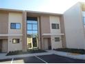 A view of the townhouse's exterior showing the building's architectural style and a parking area at 7540 Brooklyn Dr, Kissimmee, FL 34747