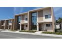 View of modern townhouse row, showcasing contemporary design with clean lines and large windows at 7540 Brooklyn Dr, Kissimmee, FL 34747