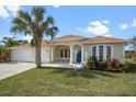Charming single-story home featuring a lush front yard, well maintained landscaping and a welcoming blue front door at 113 Grand Reserve Ct, Davenport, FL 33837