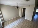 Cozy dining room with tile flooring, chandelier, and ample natural light at 1880 N Crystal Lake Dr # 65, Lakeland, FL 33801
