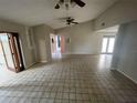Spacious living area featuring vaulted ceiling, tile flooring, ceiling fan, and natural light at 1880 N Crystal Lake Dr # 65, Lakeland, FL 33801