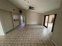 Open living room featuring tile flooring, a ceiling fan, and sliding glass doors at 1880 N Crystal Lake Dr # 65, Lakeland, FL 33801