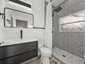 Stylish bathroom with modern vanity, patterned shower tiles, and a shower with sleek fixtures at 720 W 14Th St, Lakeland, FL 33805