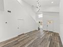 Bright, open-concept living space features soaring ceilings, modern lighting, wood floors, and a contemporary design at 720 W 14Th St, Lakeland, FL 33805