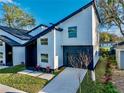 Modern two-story home featuring a black garage door and landscaped yard at 720 W 14Th St, Lakeland, FL 33805