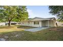 View of the home's exterior with a covered carport, showcasing its curb appeal and landscaping at 2453 Teri St, Auburndale, FL 33823