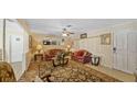 Cozy living room featuring comfortable seating, a ceiling fan, and a large rug at 2453 Teri St, Auburndale, FL 33823