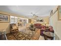 Spacious living room with a view of the dining area and large windows at 2453 Teri St, Auburndale, FL 33823