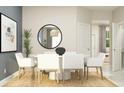 Elegant dining area featuring a round table, six chairs, and a decorative mirror, perfect for Gathering gatherings at 2603 Skyline Loop, Kissimmee, FL 34758
