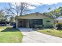 Charming single-story home with a covered carport and screened in porch at 1016 W 12Th St, Lakeland, FL 33805