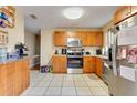 Bright kitchen with stainless steel appliances, wooden cabinets, and tile flooring at 1016 W 12Th St, Lakeland, FL 33805