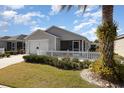 Charming single-story home with a well-manicured lawn and white picket fence offers curb appeal at 1654 Indigo Ave, The Villages, FL 32162