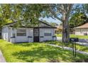 Delightful home offering a lush green lawn, sidewalk and mailbox at 828 W 13Th St, Lakeland, FL 33805