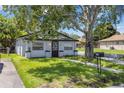 Cozy home featuring a well-maintained lawn, sidewalk, and a mailbox at 828 W 13Th St, Lakeland, FL 33805