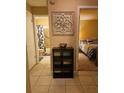 Hallway with decorative wall art leading to bathroom with tub and bedroom at 3881 Villa Rose Ln, Orlando, FL 32808