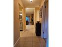 Inviting hallway featuring tile flooring and seamless transitions to the kitchen and living areas at 3881 Villa Rose Ln, Orlando, FL 32808