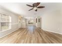 Inviting living space with wood-look floors, ceiling fan, and dining area at 5331 River Rock Rd, Lakeland, FL 33809